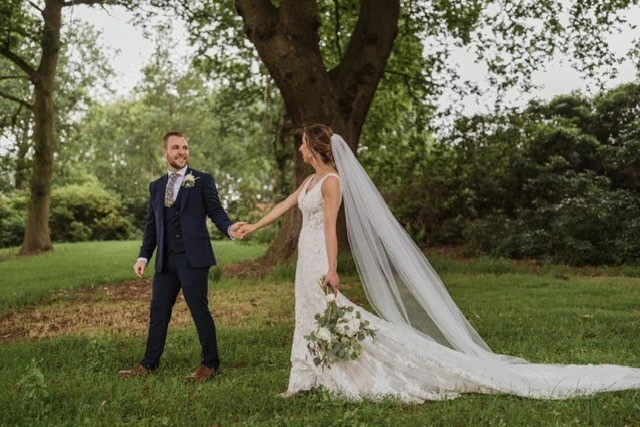 Bride and groom walking the the garden