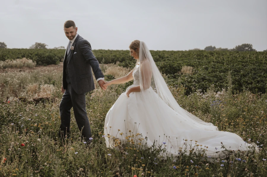 Bride and groom in a wild meadow