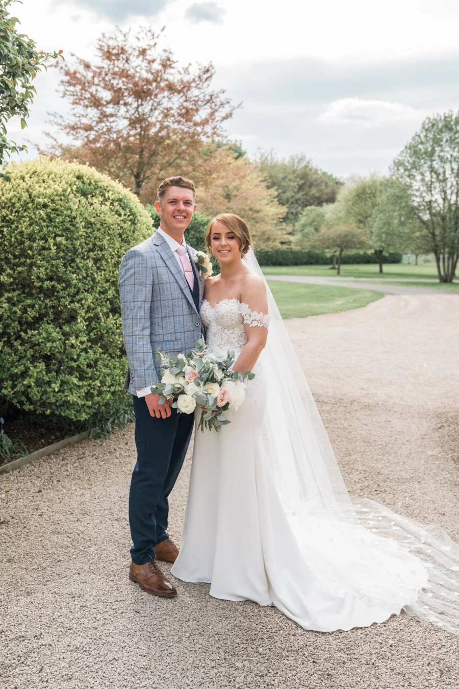 Bride and groom on path